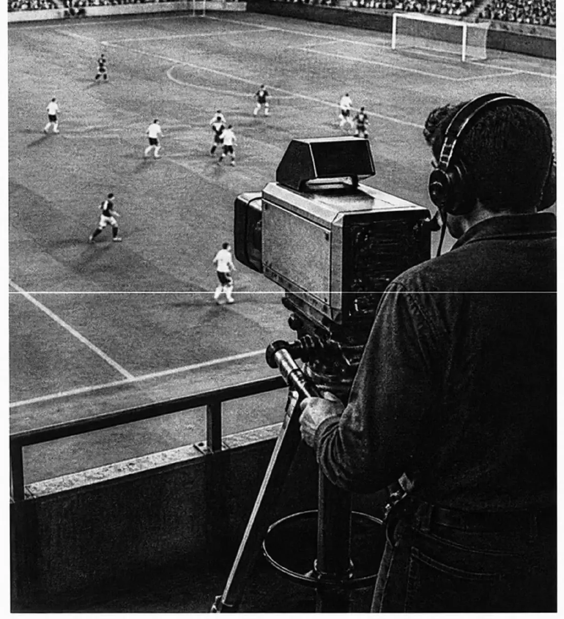 A camera operator filming a football match